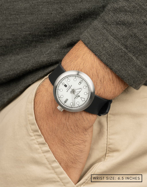 Man wearing the Zanskar watch, with his hand in his pocket, highlights the dial’s unique white color and textured finish.